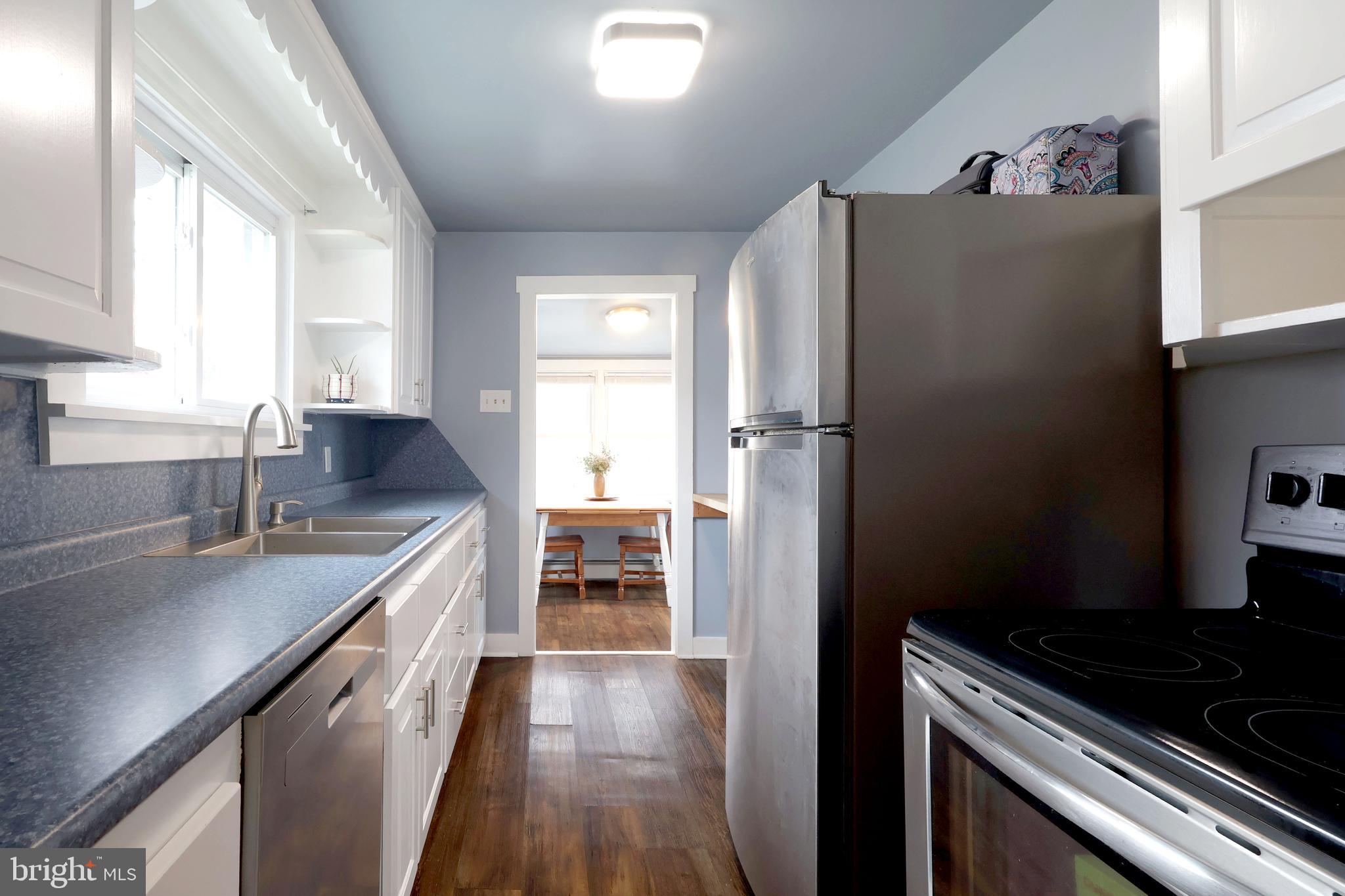 746 South Nixon Road Pine Grove Mills, PA 16868 - Photo 12 of 38 a kitchen with a refrigerator and a sink