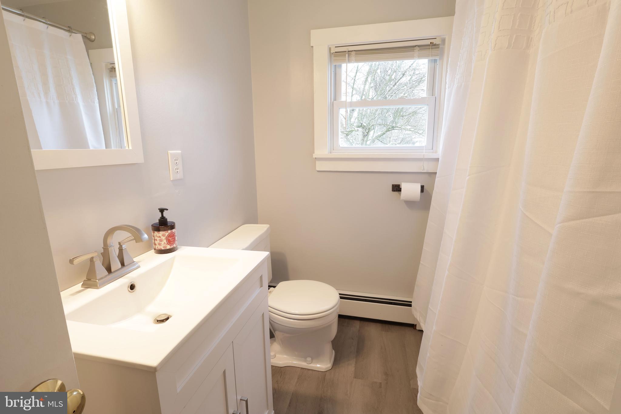 746 South Nixon Road Pine Grove Mills, PA 16868 - Photo 23 of 38 a bathroom with a sink a toilet and a window