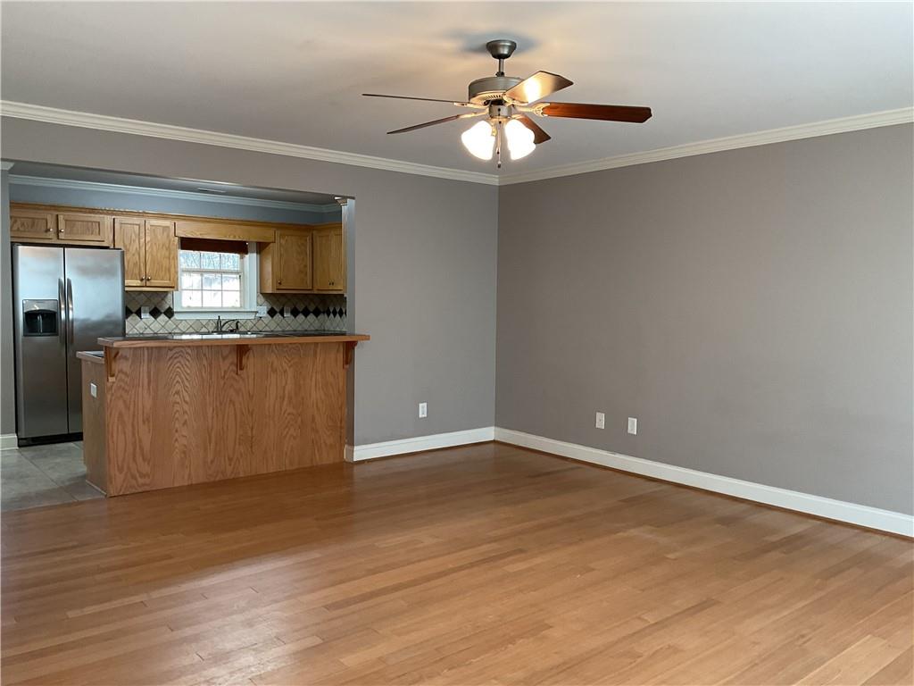 10 Sarah Street Northwest Rome, GA 30165 - Photo 5 of 14 a view of a kitchen with wooden floor and a ceiling fan