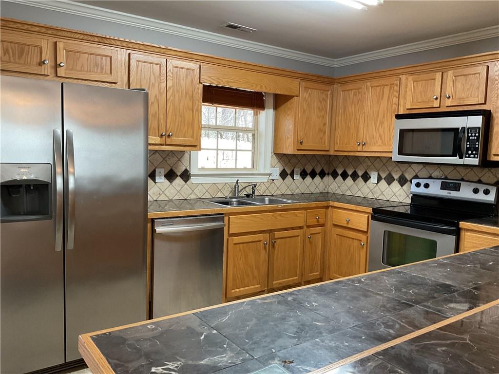 10 Sarah Street Northwest Rome, GA 30165 - Photo 6 of 14 a kitchen with a refrigerator sink and microwave