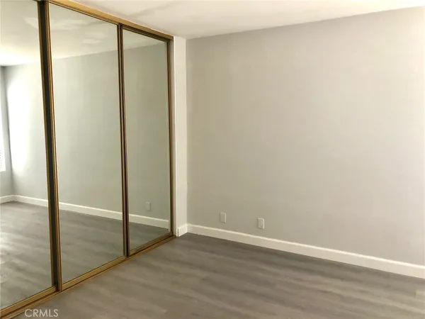 an empty room with wooden floor and a window