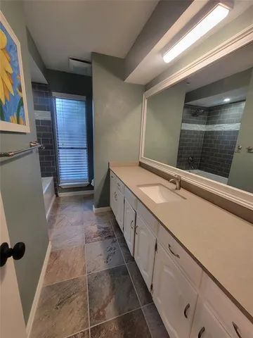 a bathroom with a double vanity sink and a mirror