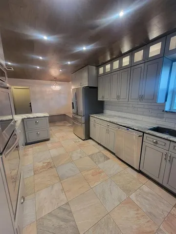 a kitchen with refrigerator and cabinets