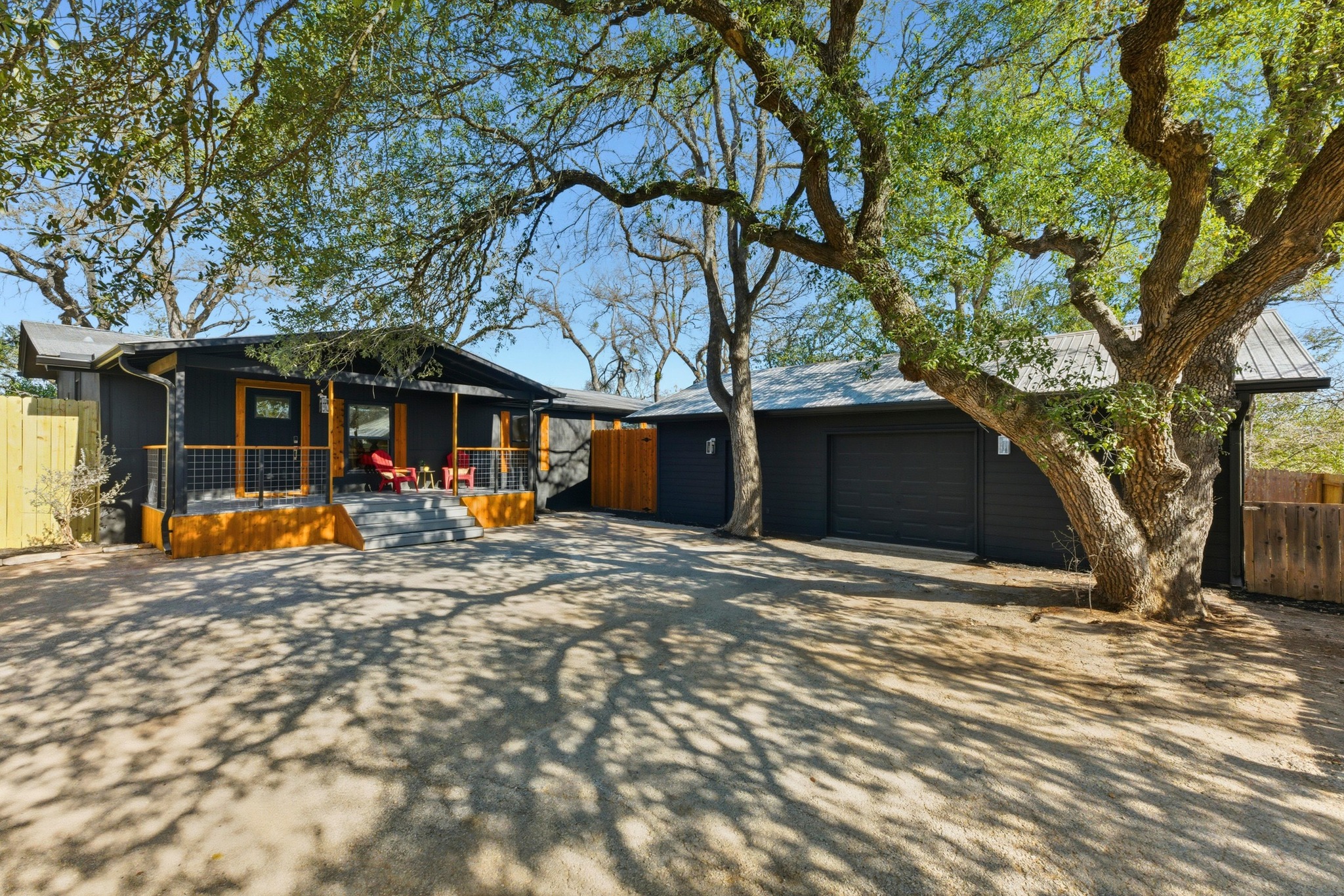 View of front of home featuring a front porch, driveway, and an garage/workshop