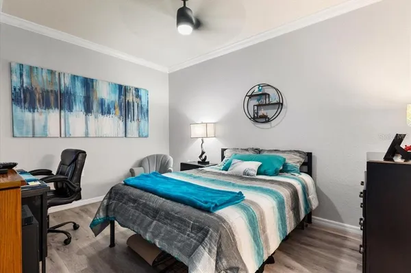 a bedroom with a bed and flat tv screen on the dresser