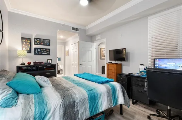 a bedroom with a bed and a flat screen tv