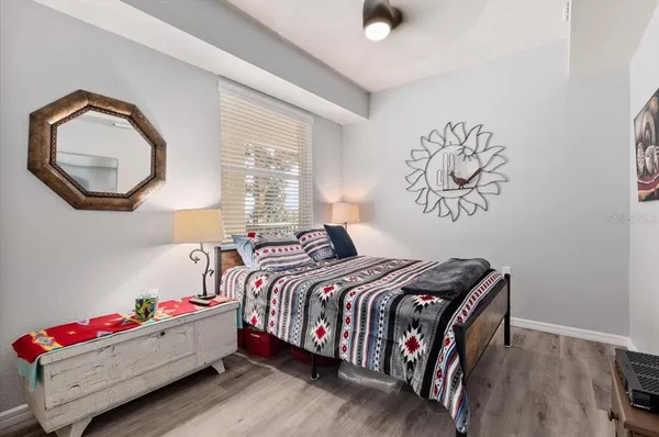 a bedroom with bed and a bookshelf