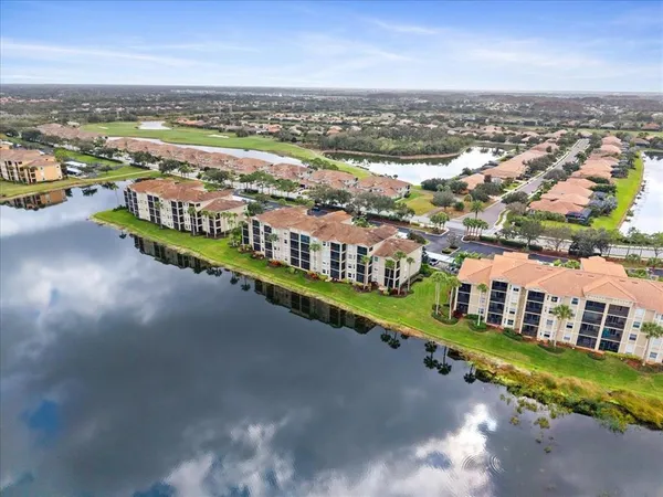 an aerial view of residential houses with outdoor space and river view