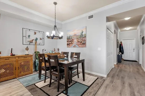 a view of a dining room with furniture and chandelier
