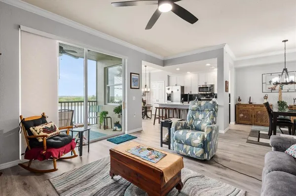 a living room with furniture and kitchen view