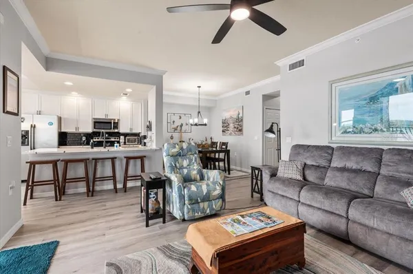 a kitchen with kitchen island granite countertop a table chairs sink and cabinets