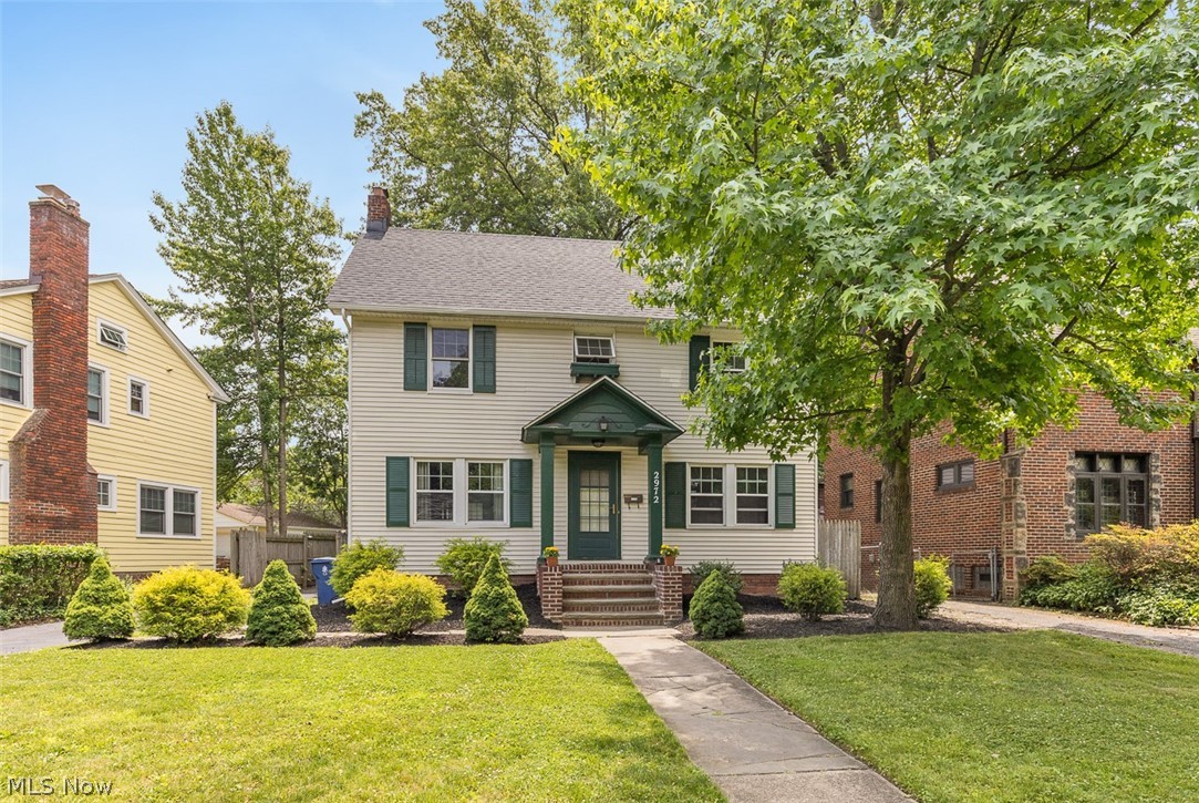 2972 Yorkshire Road Cleveland Heights, OH 44118 - Photo 3 of 44 Traditional-style residence featuring light-colored siding, dark green shutters, and a covered entry