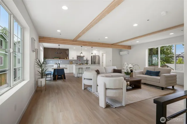 a living room with furniture flat screen tv and outdoor view