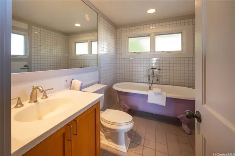 a bathroom with a sink a toilet and mirror