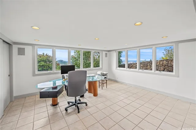 a view of a workspace with furniture and a window