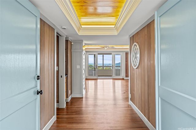 a view of hallway with wooden floor and sliding door