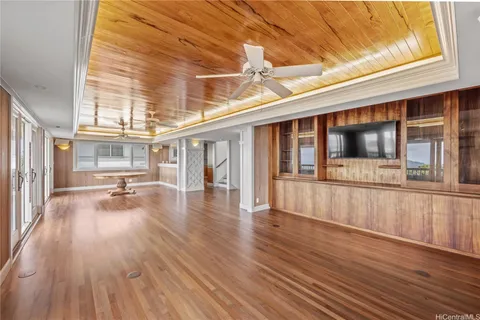 a view of a house with pool and wooden floor