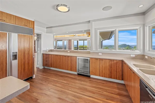 a view of a kitchen with a sink and a window