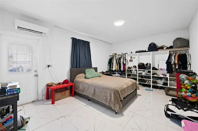 a bedroom with a bed and a desk