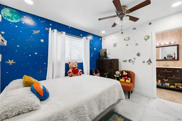 a bedroom with a bed and a car