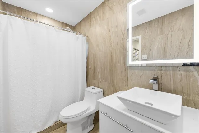 a bathroom with a toilet a sink and a shower