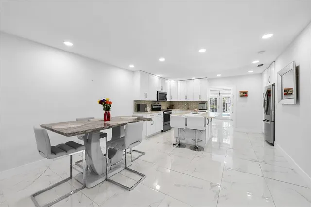 a view of kitchen with dining table and chairs