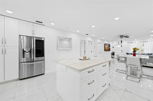 a large white kitchen with cabinets