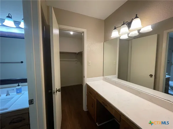 an empty room with wooden floor and window