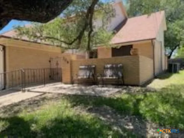 a view of a house with wooden fence