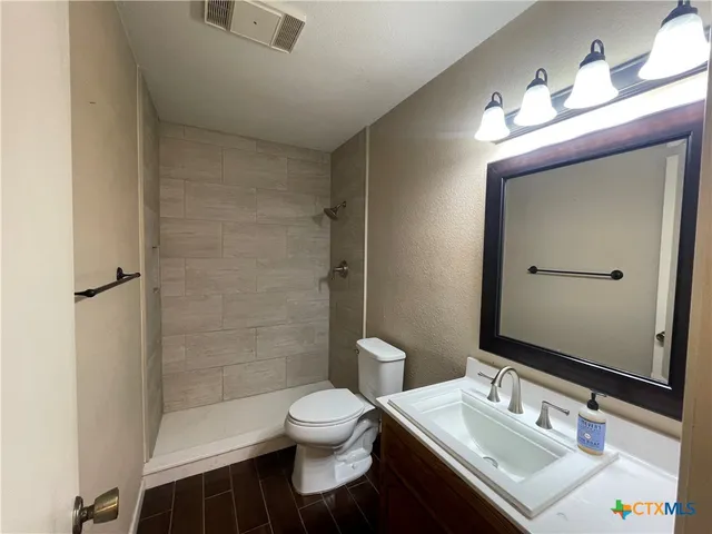 an empty room with wooden floor and window