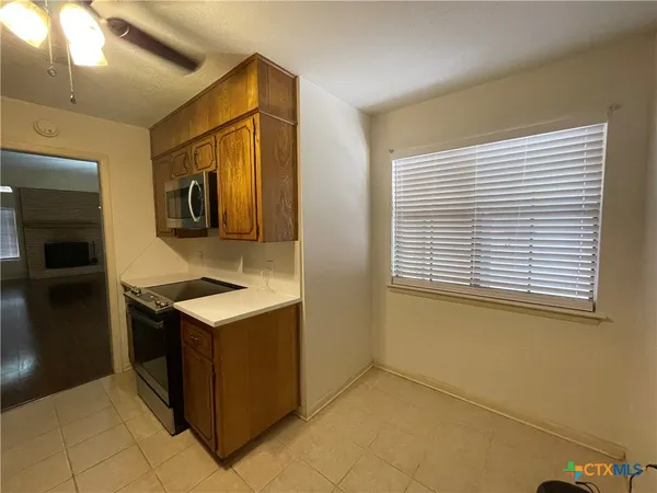 a kitchen with stainless steel appliances granite countertop a sink and a refrigerator