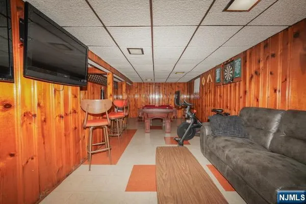 a living room with furniture a chandelier and a wooden floor
