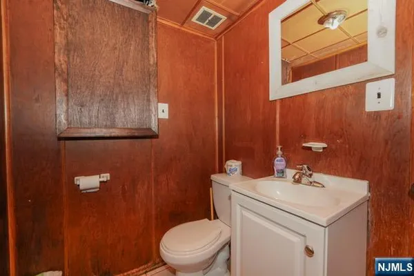 a bathroom with a sink a toilet and mirror