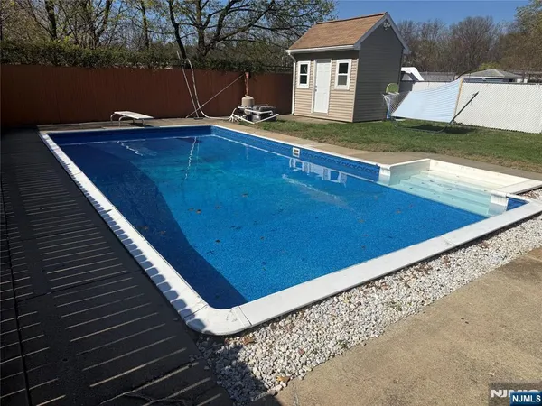 a view of a pool with a yard