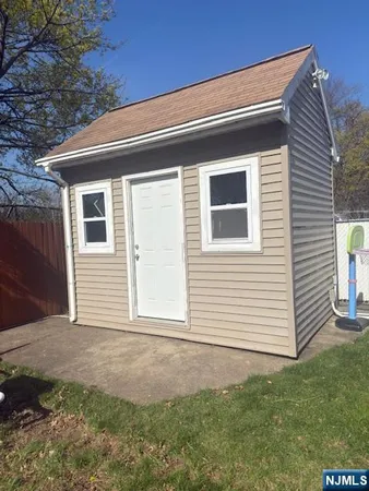 a view of backyard of house and garage