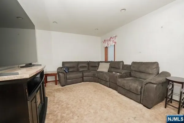 a living room with a couch and a stove top oven