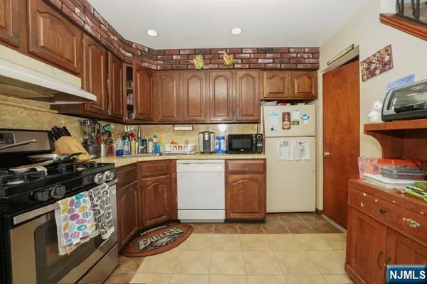 a kitchen with refrigerator and cabinets