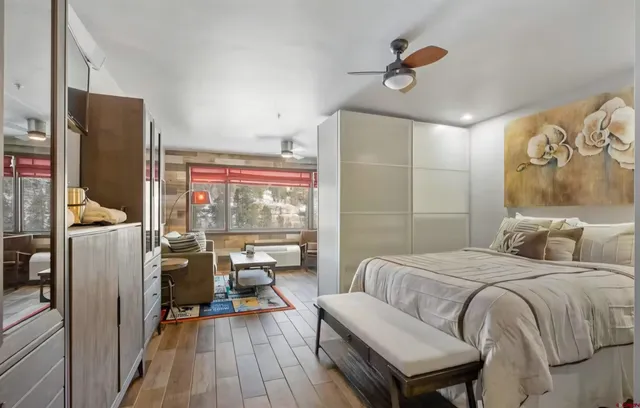 a bedroom with a bed and a chandelier