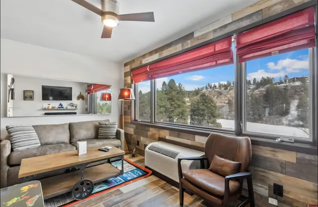 a living room with furniture and a floor to ceiling window