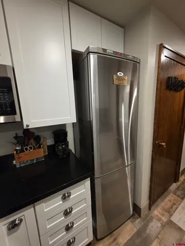 a kitchen with a refrigerator and cabinets