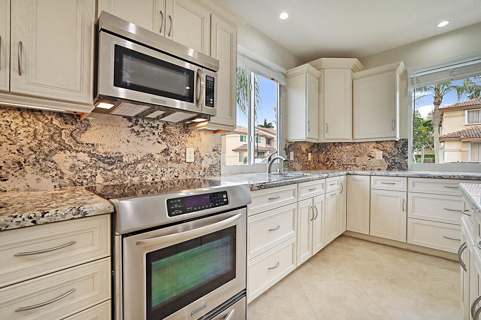 6819 Via Regina Boca Raton, FL 33433 - Photo 15 of 39 a kitchen with granite countertop cabinets stainless steel appliances and a sink