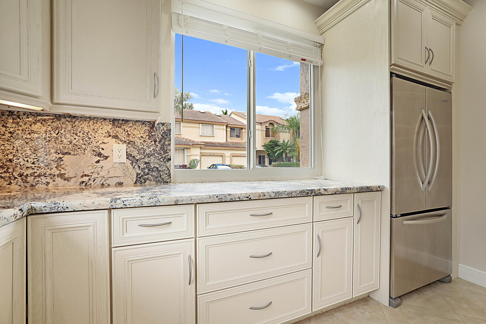 6819 Via Regina Boca Raton, FL 33433 - Photo 16 of 39 a kitchen with granite countertop cabinets stainless steel appliances and a granite counter tops