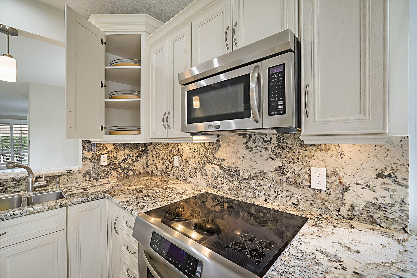 6819 Via Regina Boca Raton, FL 33433 - Photo 18 of 39 a kitchen with granite countertop white cabinets and stainless steel appliances