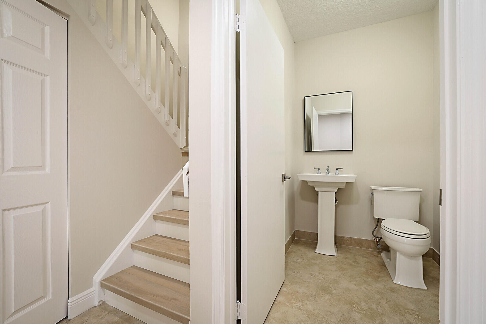 6819 Via Regina Boca Raton, FL 33433 - Photo 23 of 39 a bathroom with a toilet sink and a mirror