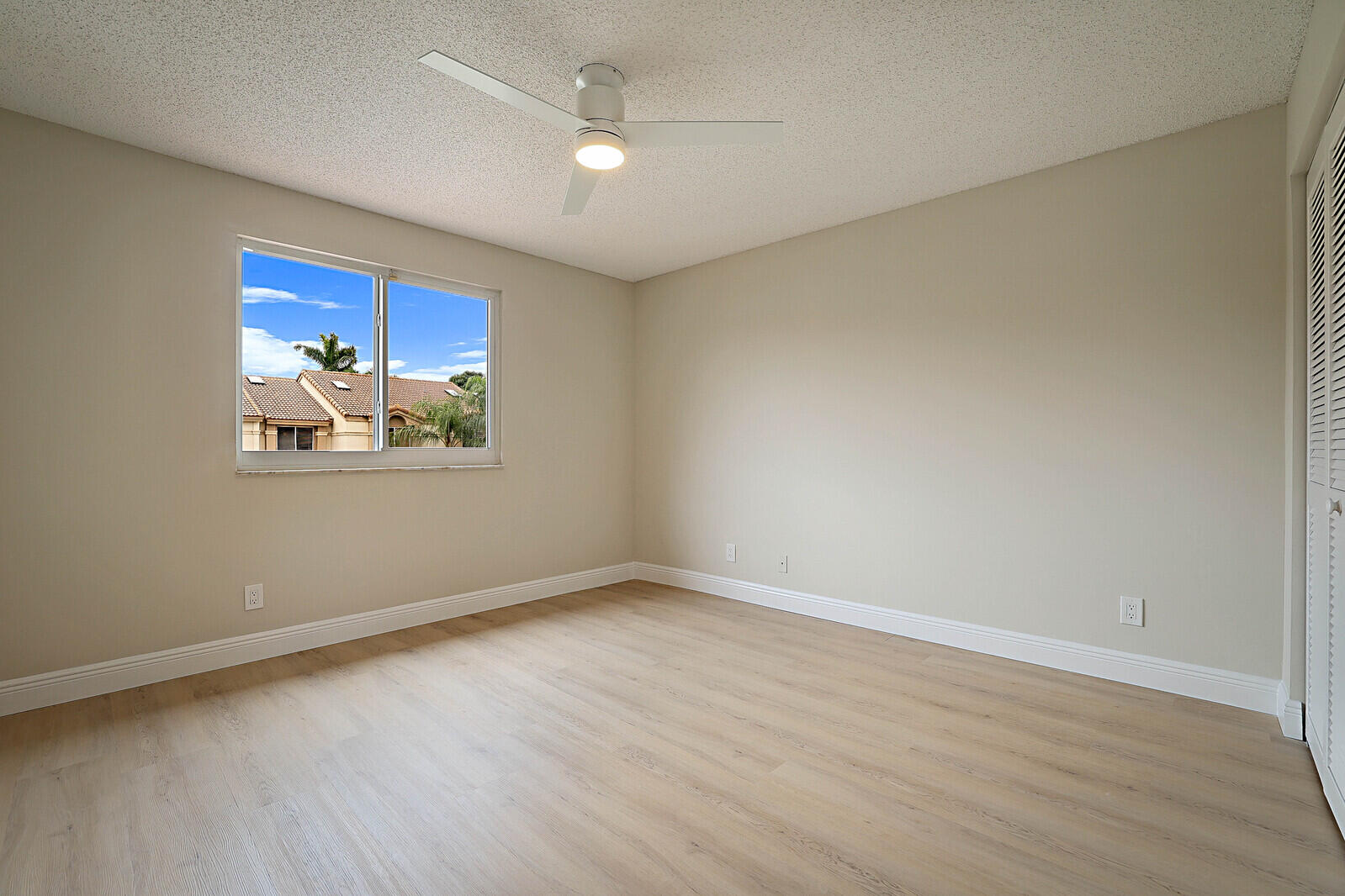 6819 Via Regina Boca Raton, FL 33433 - Photo 33 of 39 wooden floor in an empty room with a window