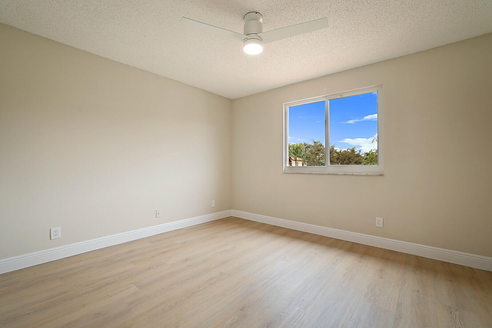 6819 Via Regina Boca Raton, FL 33433 - Photo 35 of 39 an empty room with wooden floor and windows