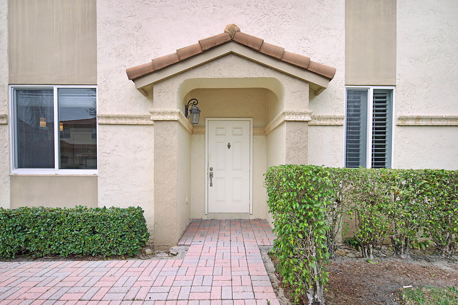 6819 Via Regina Boca Raton, FL 33433 - Photo 5 of 39 a front view of a house with garden