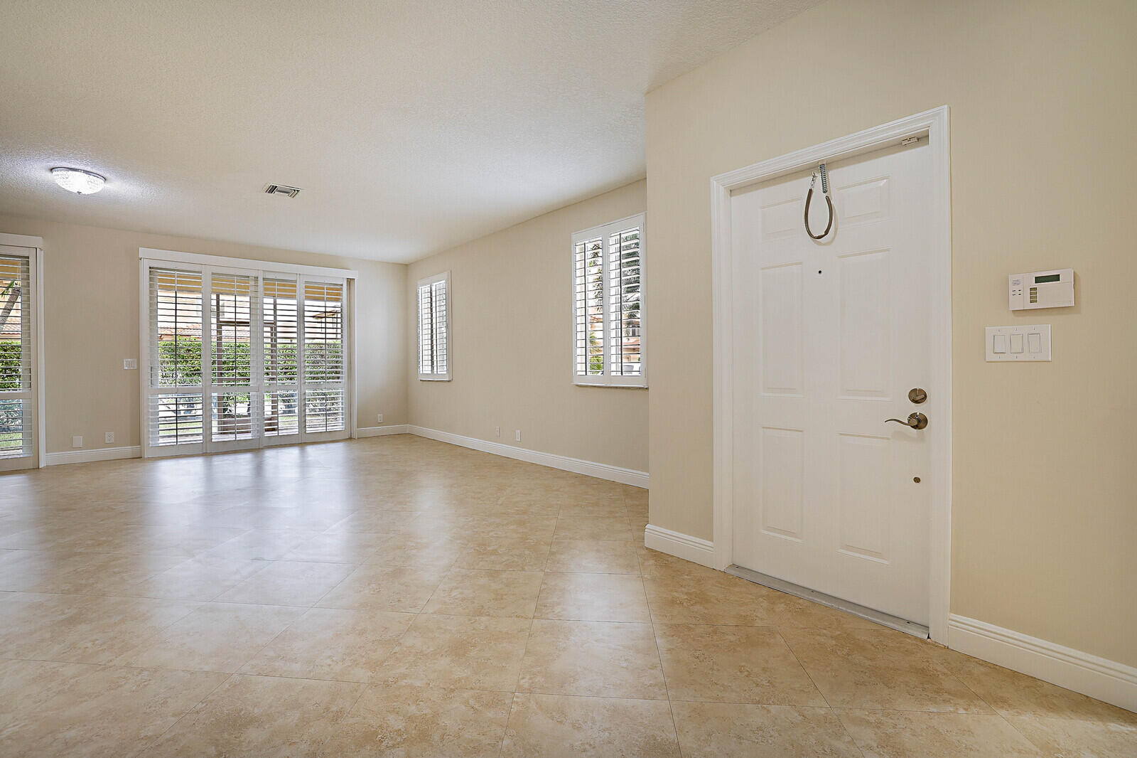 6819 Via Regina Boca Raton, FL 33433 - Photo 6 of 39 wooden floor in an empty room with a window