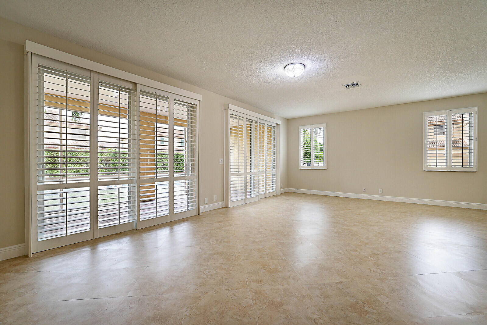 6819 Via Regina Boca Raton, FL 33433 - Photo 10 of 39 a view of an empty room with wooden floor and a window