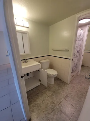 a bathroom with a toilet and a shower